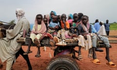 Children on a cart cross the border between Sudan and Chad.