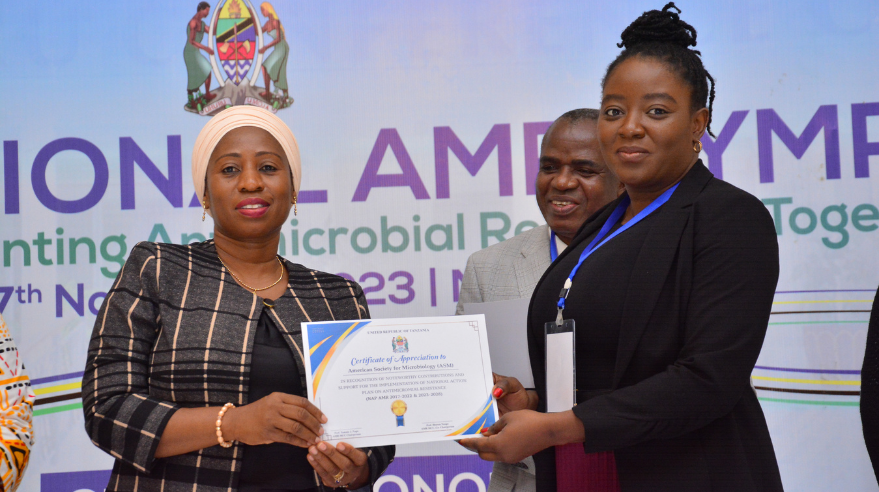 Ade Olarewaju receives a certificate of appreciation from Hon. Ummy Ally Mwalimu.
