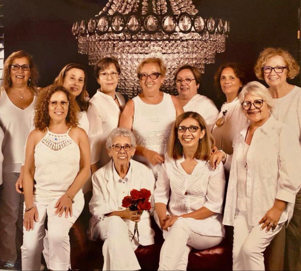 A group of women wearing white clothes