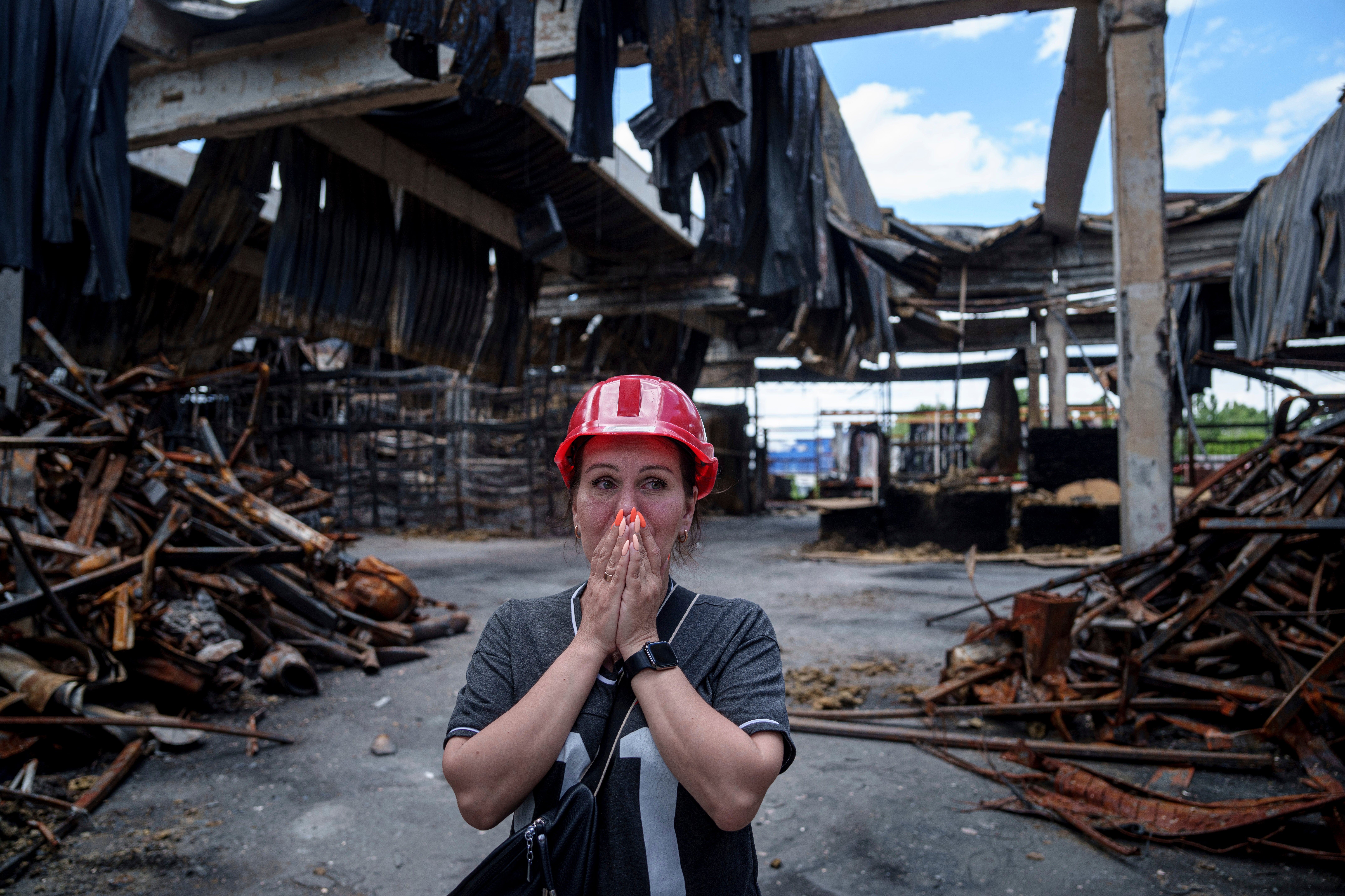Nina Korsunova gets emotional as she walks inside the destroyed Epicenter shopping complex in Kharkiv, Ukraine, hit by Russian glide bombs earlier this month. At least 11 people were killed.