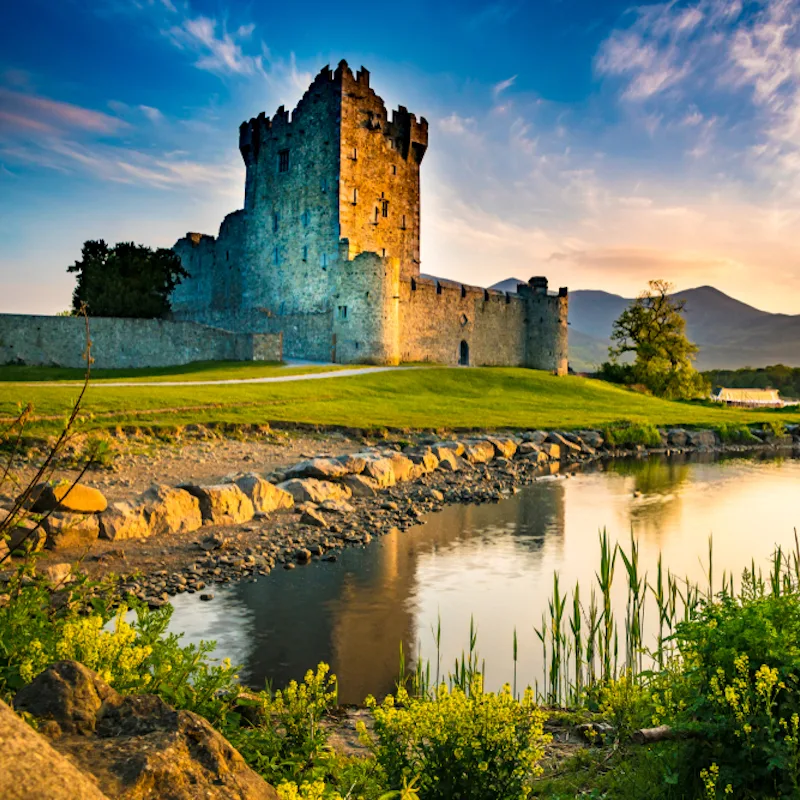 Castle in Ireland with pond in the foreground and blue skies
