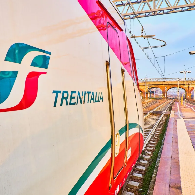 A train of Trenitalia in an Italian train station at sunset. Asti, Piedmont, Italy.