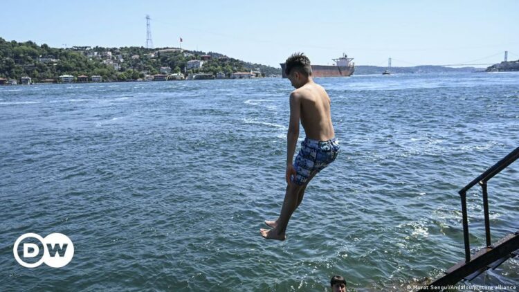 A boy jumps from a staircase into the Bosphorus.