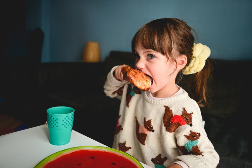A girl eating chicken. Source: Getty (File)