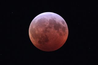 The Super Blood Wolf Moon eclipse of Jan. 20-21, 2019, captured at mid-totality by Imelda Joson and Edwin Aguirre from the suburbs of Boston.