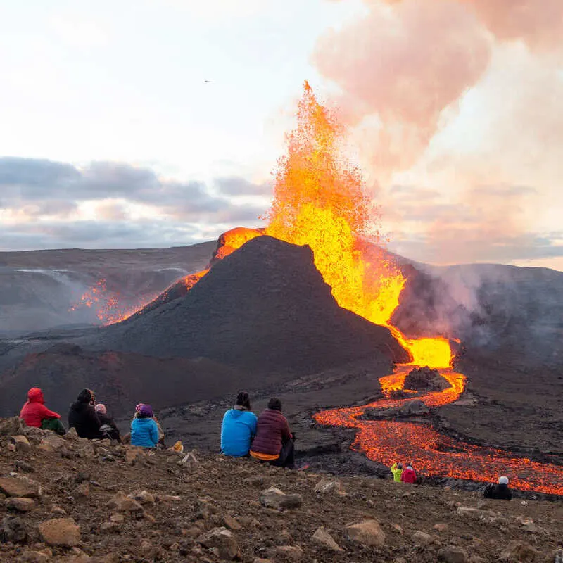 Tourists Watching A Volcano Erupting In Iceland, Europe