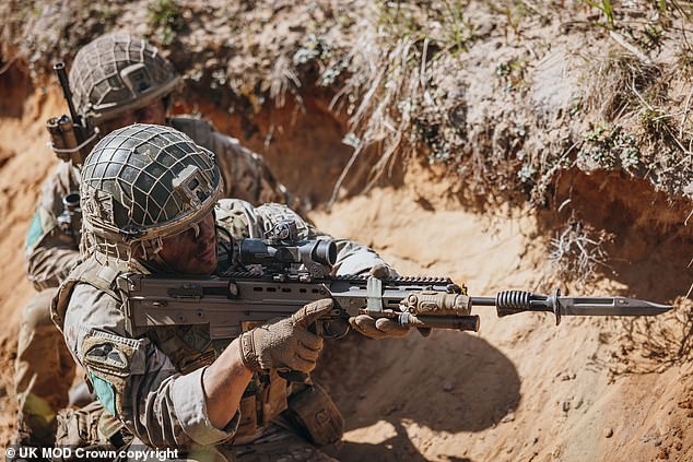A British paratrooper takes part in a live-fire exercise during Exercise Swift Response on May 4