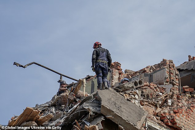 Rescuers remove rubble from partially destroyed residential building in Kharkiv after night Russian missile attack on May 31