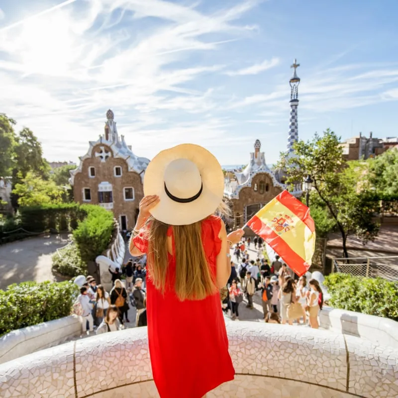 woman holding spanish flag in park guell, Barcelona