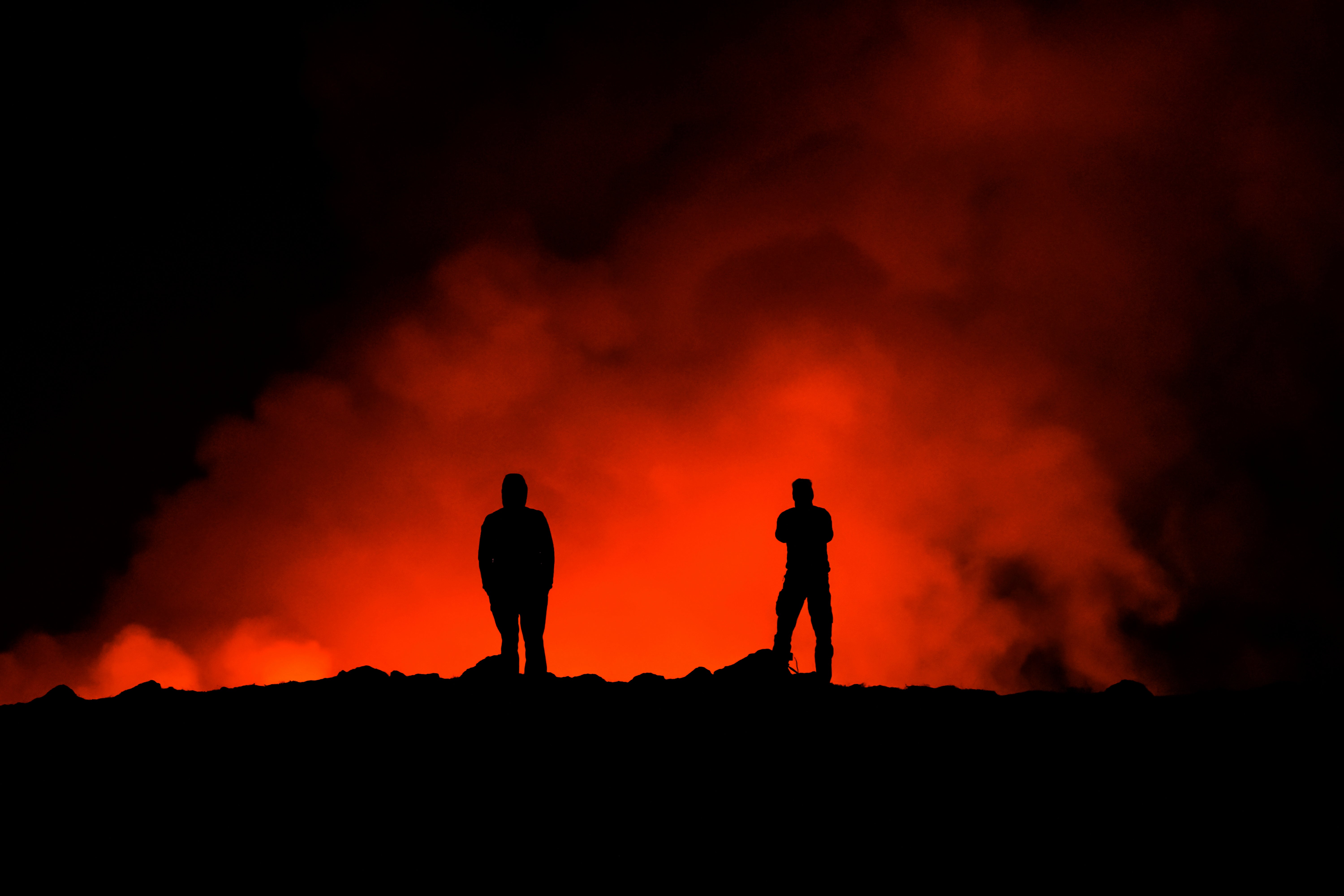 People look at the volcano erupting, north of GrindavÃ­k, Iceland, Thursday, 8 February 2024