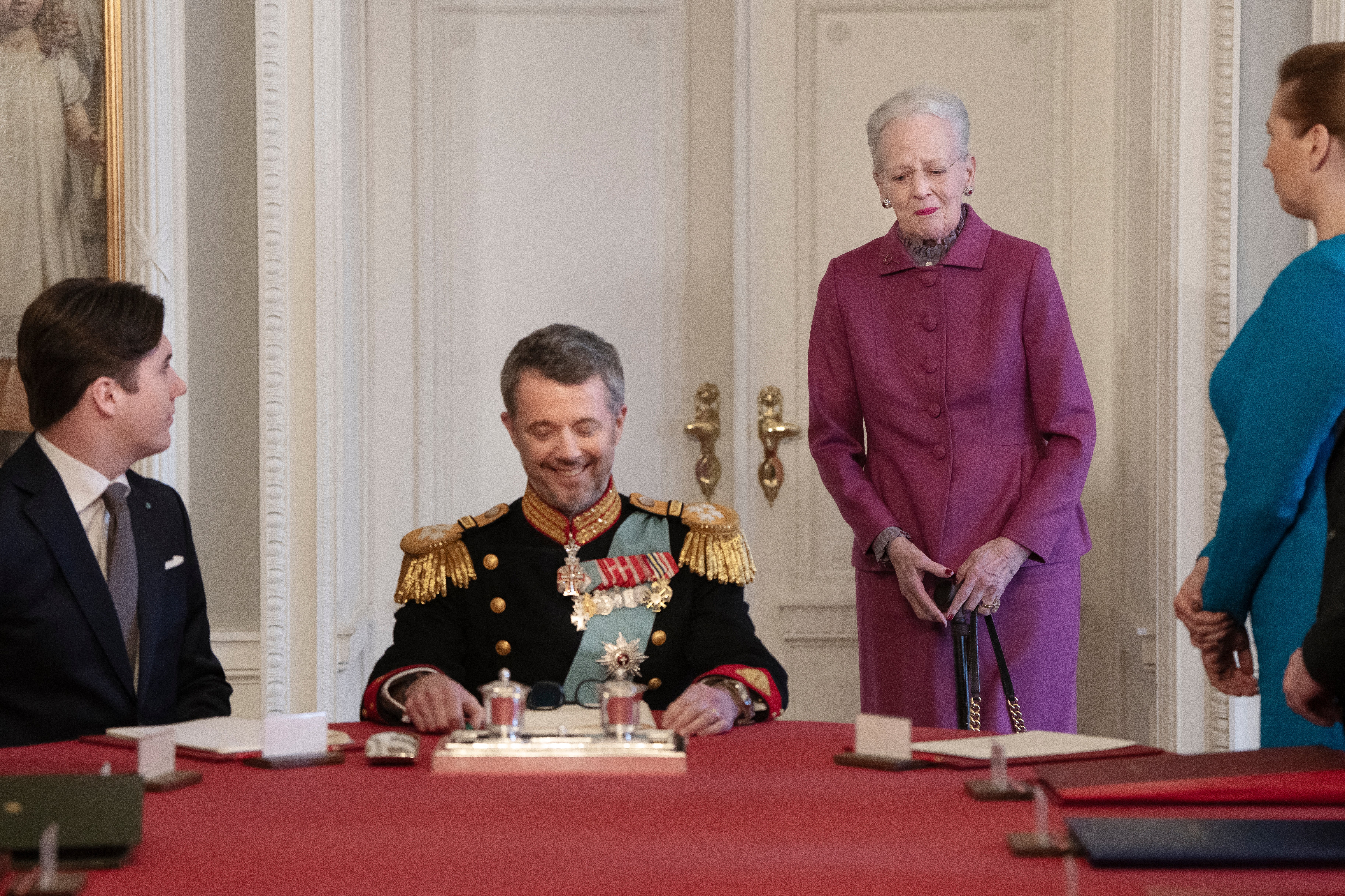 After signing the declaration of abdication Queen Margrethe II of Denmark, second right, leaves the seat at the head of the table to her son King Frederik X of Denmark