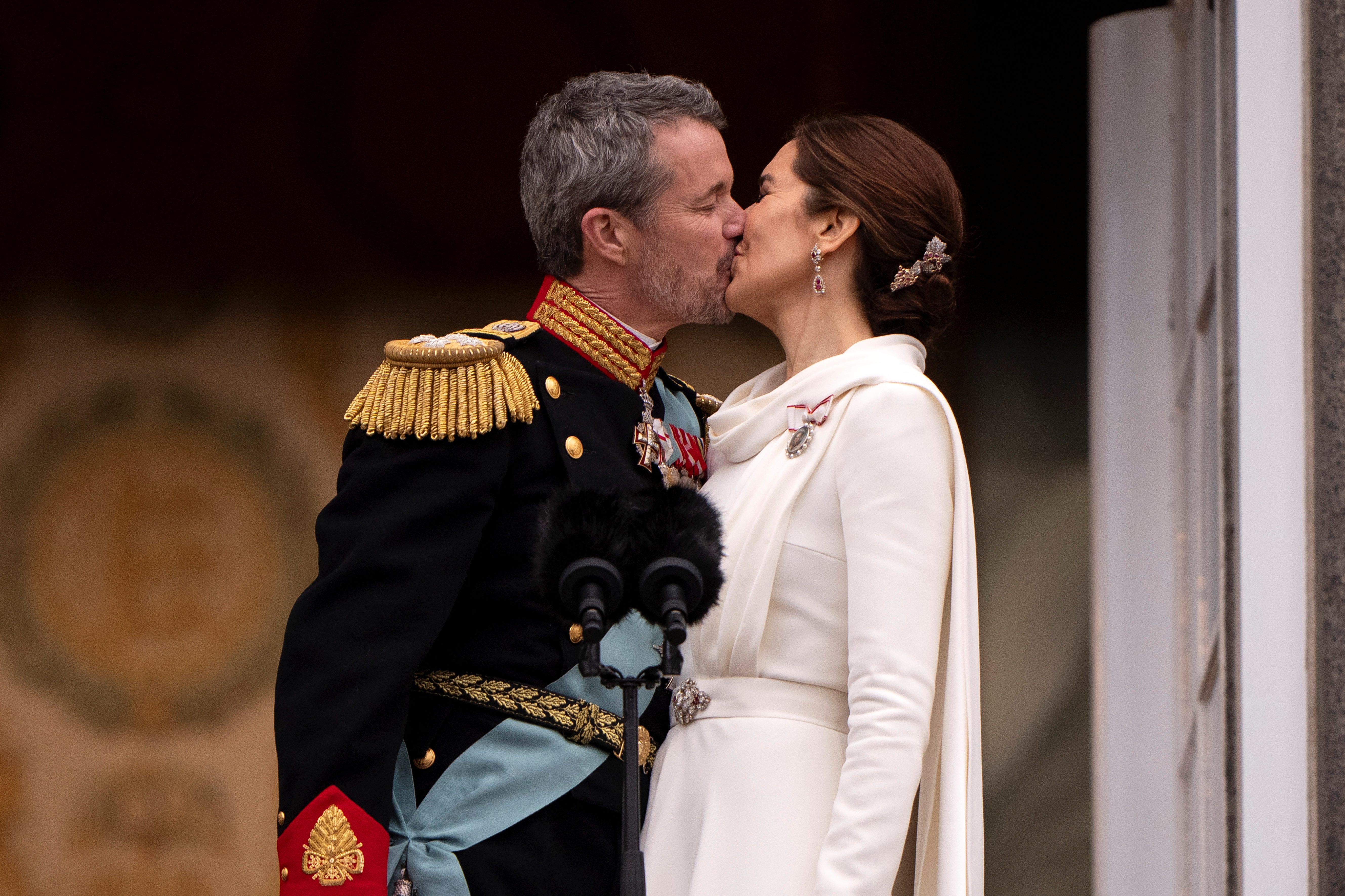 Denmark's newly proclaimed King Frederik and Queen Mary kiss on the balcony of Christiansborg Palace
