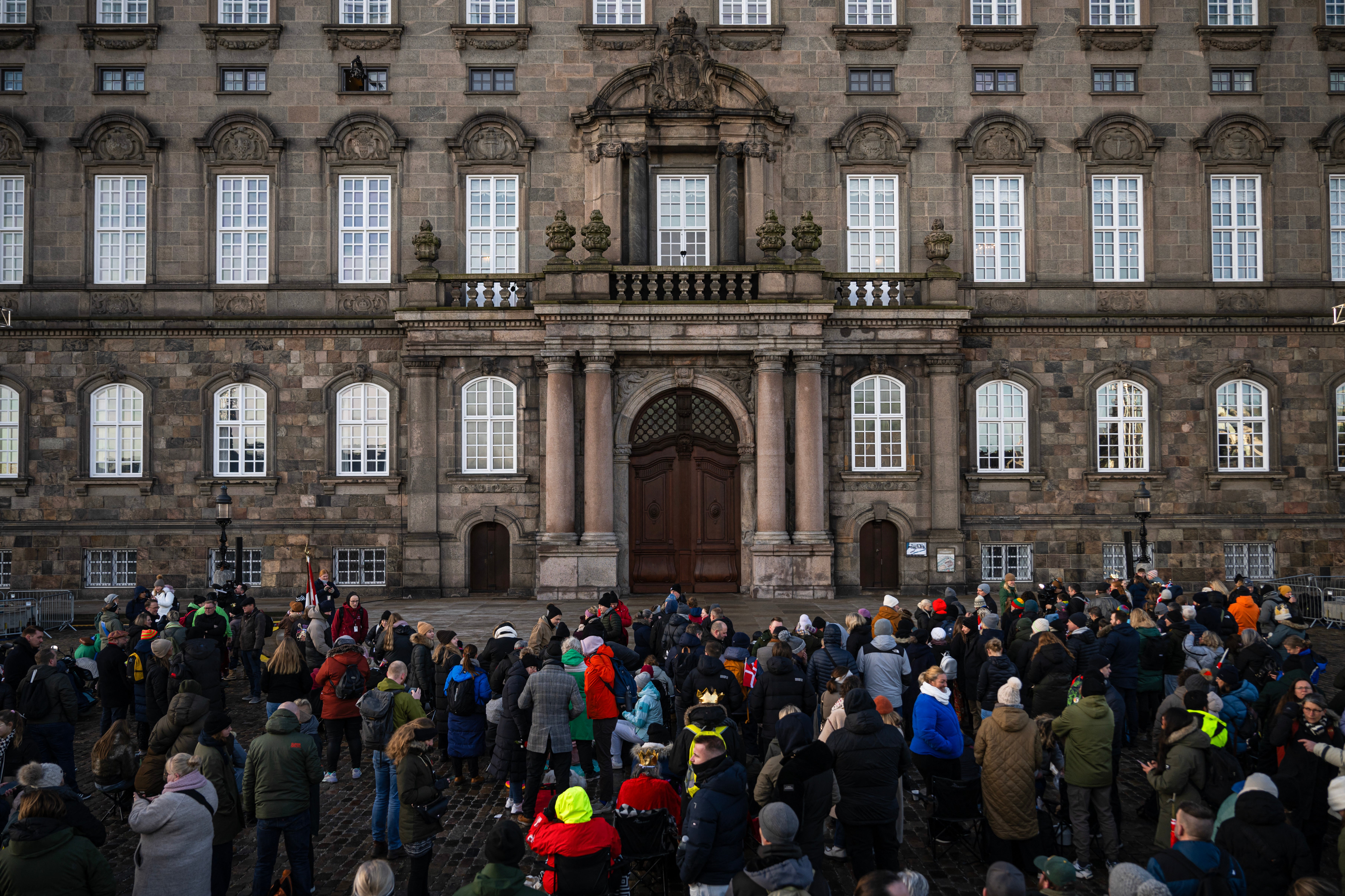 People gather in the early morning at Christiansborg Palace Square ahead of the proclamation of the abdication