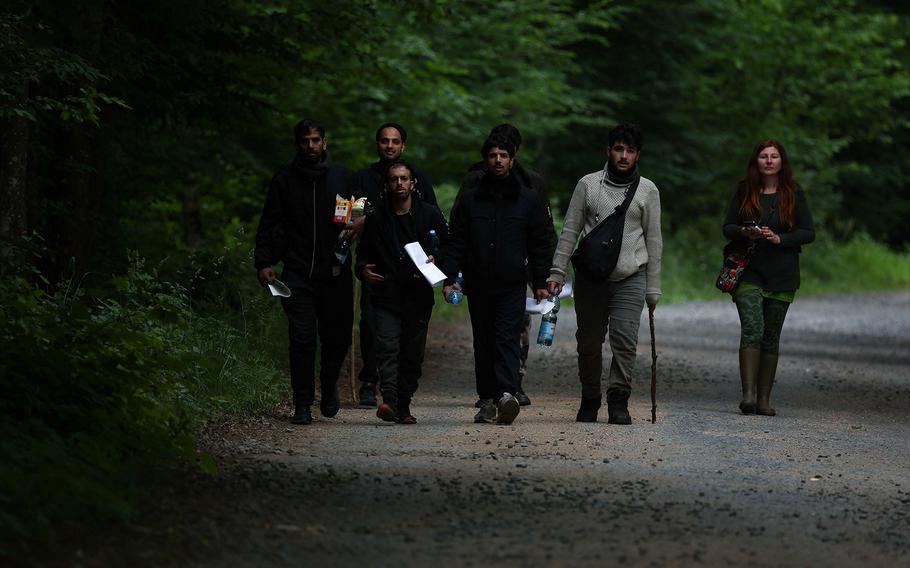 A group of migrants (mainly from Yemen) walk with activist Agata Kluczewska, who runs a local migrant support group, after they crossed Belarusian-Polish border in Grudki, Poland, June 4, 2024. 