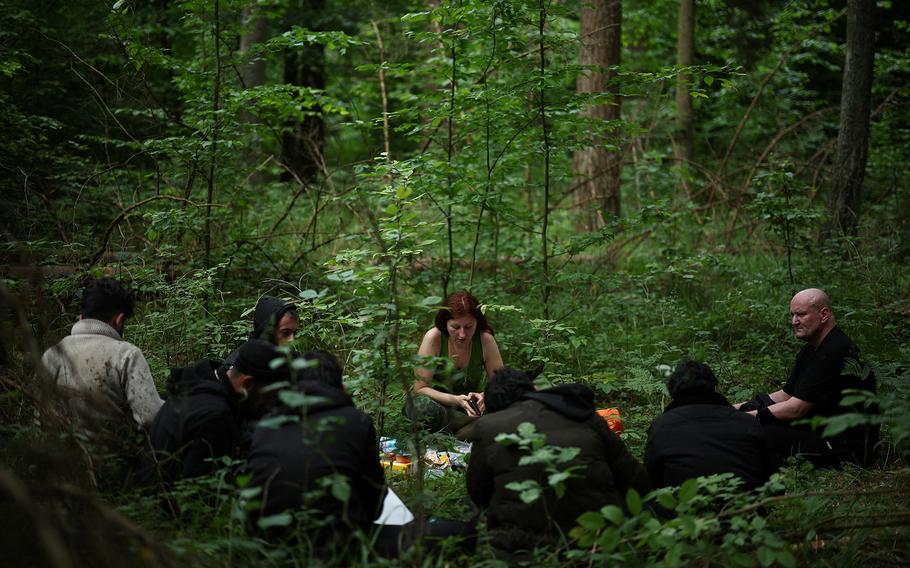 A group of migrants, mainly from Yemen, receive help from humanitarian organisation activists in the forest near Grudki, Poland, June 4, 2024. 