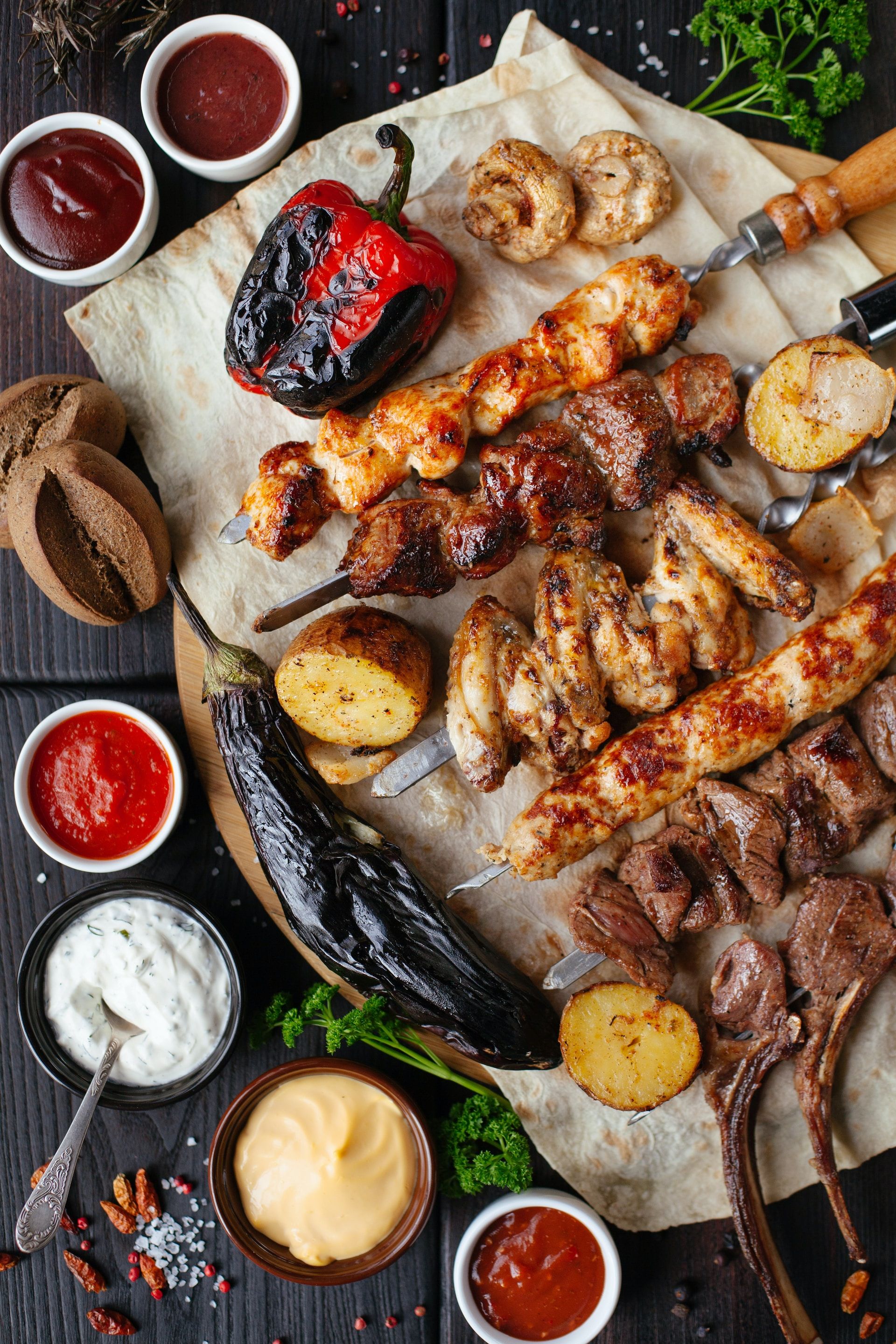 Platter of savory Greek food, featuring grilled meat and vegetables.