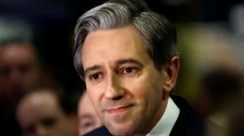 Reuters A close up image of Taoiseach Simon Harris speaking to the media in Dublin
