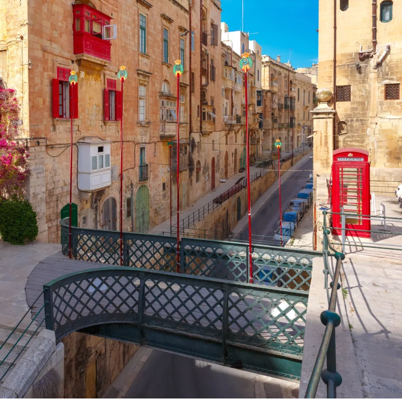 Typical Maltese street with British red phone box