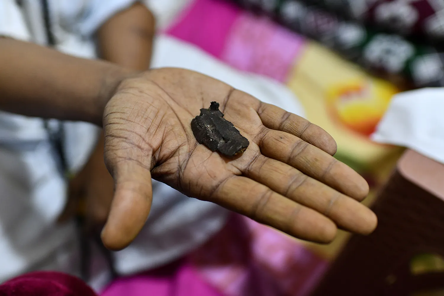 Hassan’s father holds a fragment of an artillery shell that landed in his family’s home.