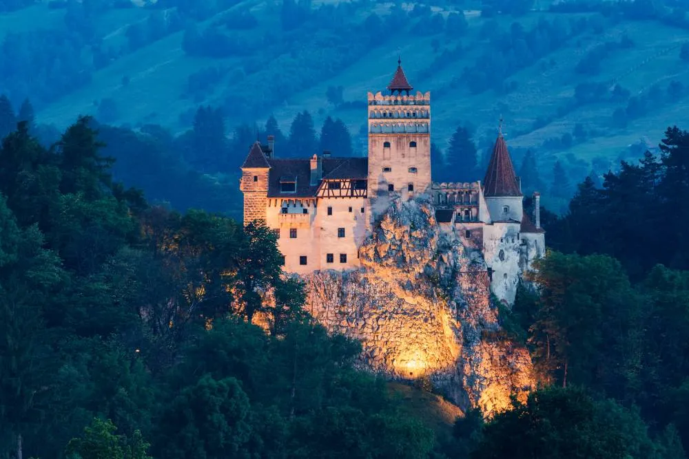 Bran Castle illuminated in evening — Getty Images