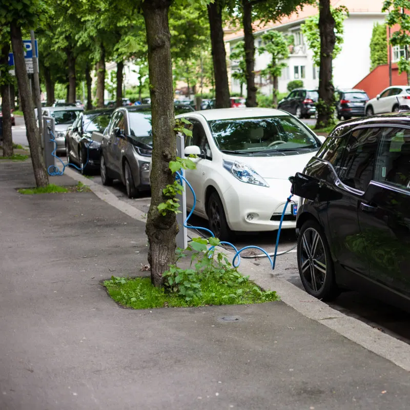 electric cars charging next to clean sidewalk in oslo