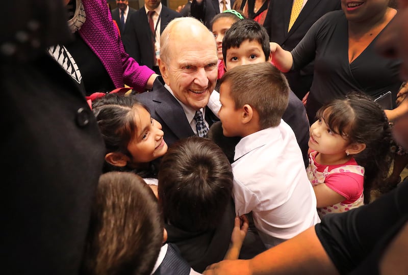 President Russell M. Nelson greets children after a devotional.