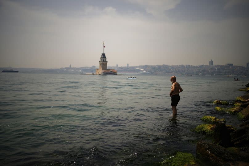 A man cool off at the Bosphorus during a hot day in Istanbul, Turkey, Thursday, 13 June, 2024. 