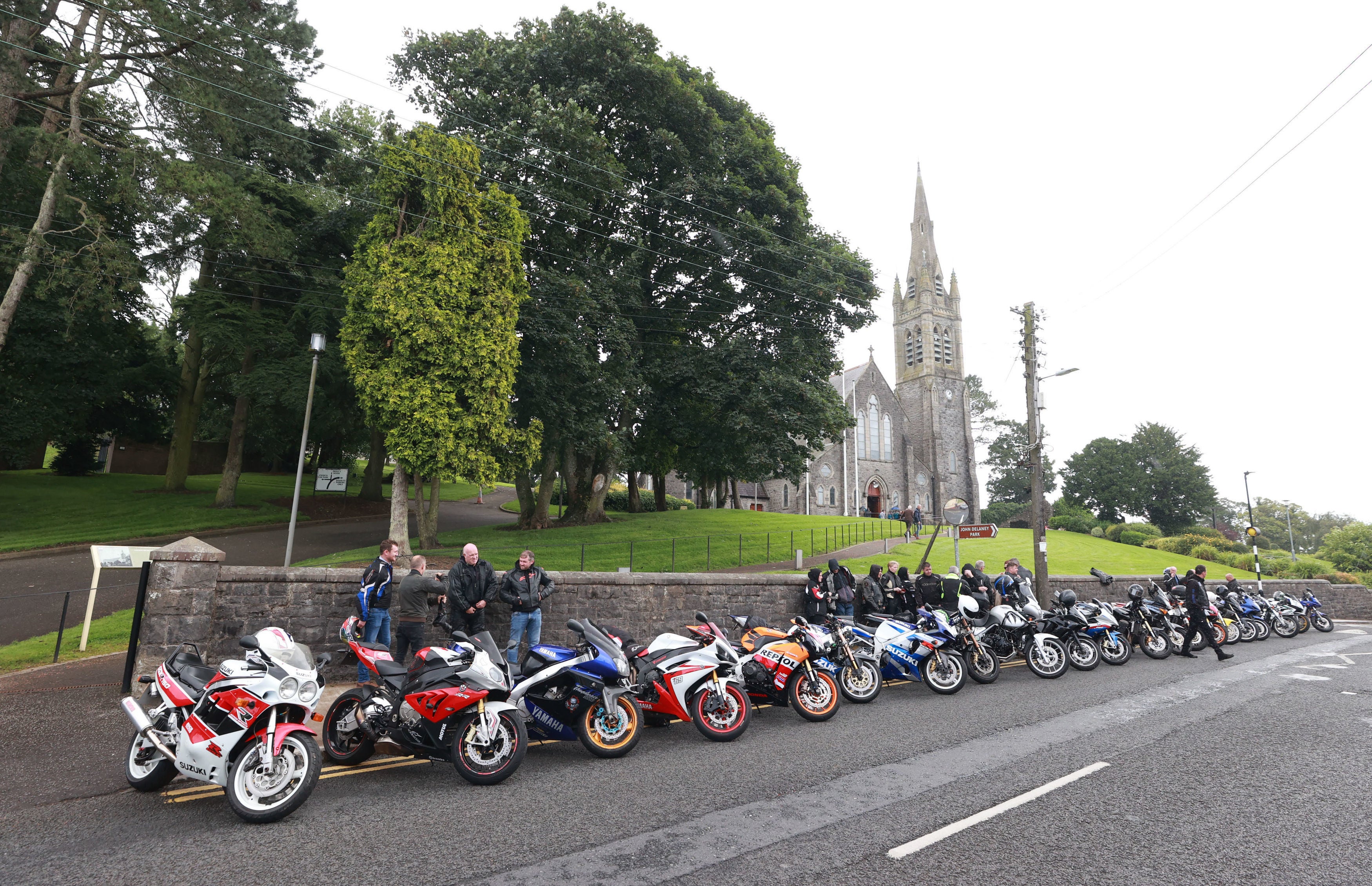 Motorcycle riders and local motorcycle club members outside the Sacred Heart Chapel