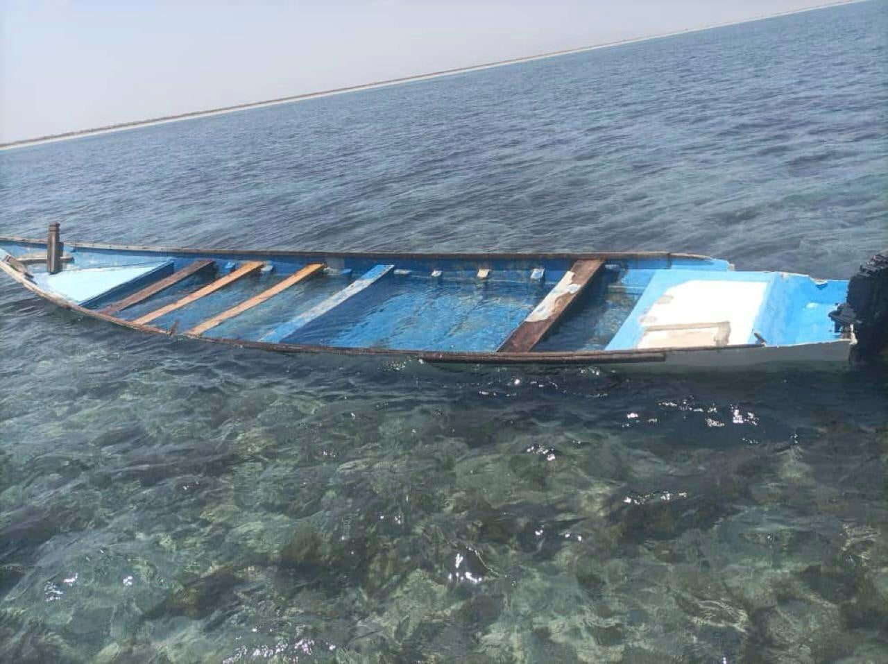 A capsized boat is seen near the coastal town of Obock in northeastern Djibouti Tuesday