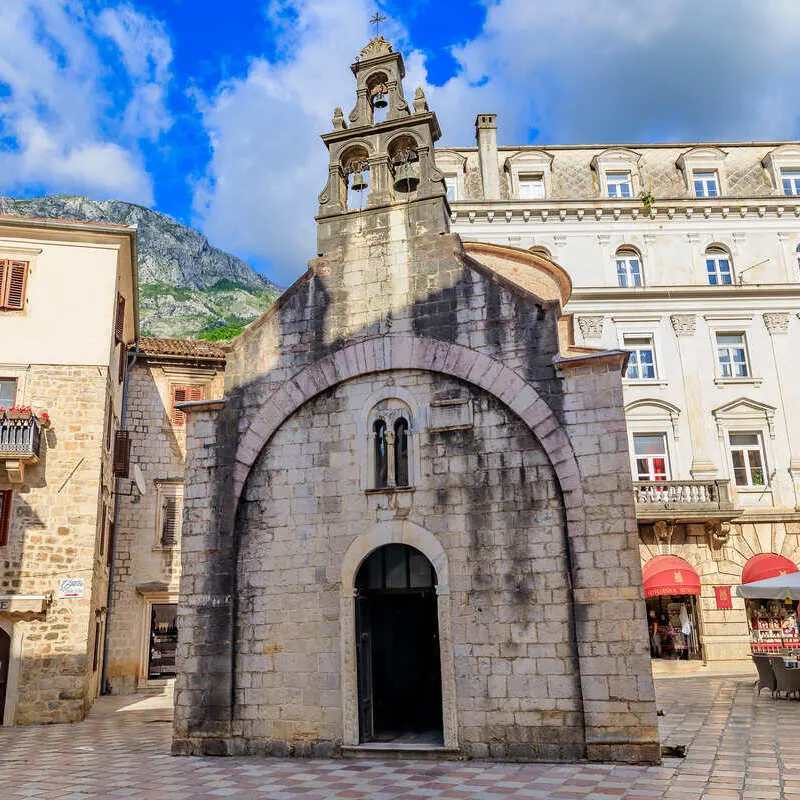 Historic Stone Church In Old Town Kotor, A Medieval Walled Town In The Bay Of Kotor, Montenegro, Southeastern Europe