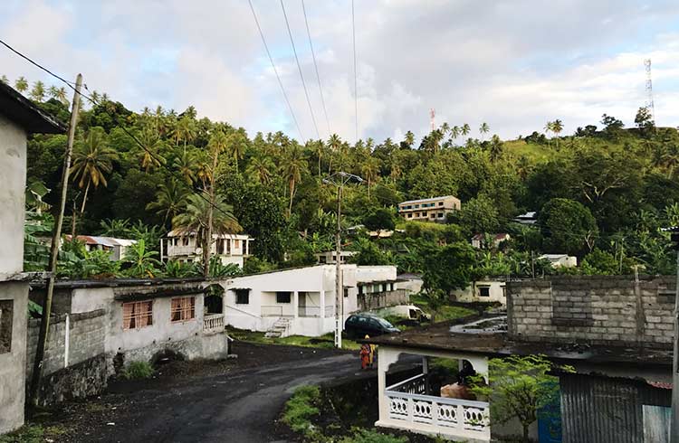 A road and buildings surrounded by jungle in Ouziouani, Comoros
