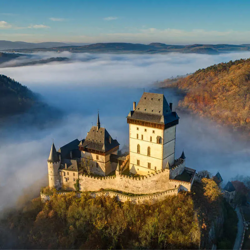 Aerial View Of Karlstejn Castle Surrounded In Fog In The Historic Town Of Karlstejn Near Prague, Czechia, Czech Republic, Central Europe
