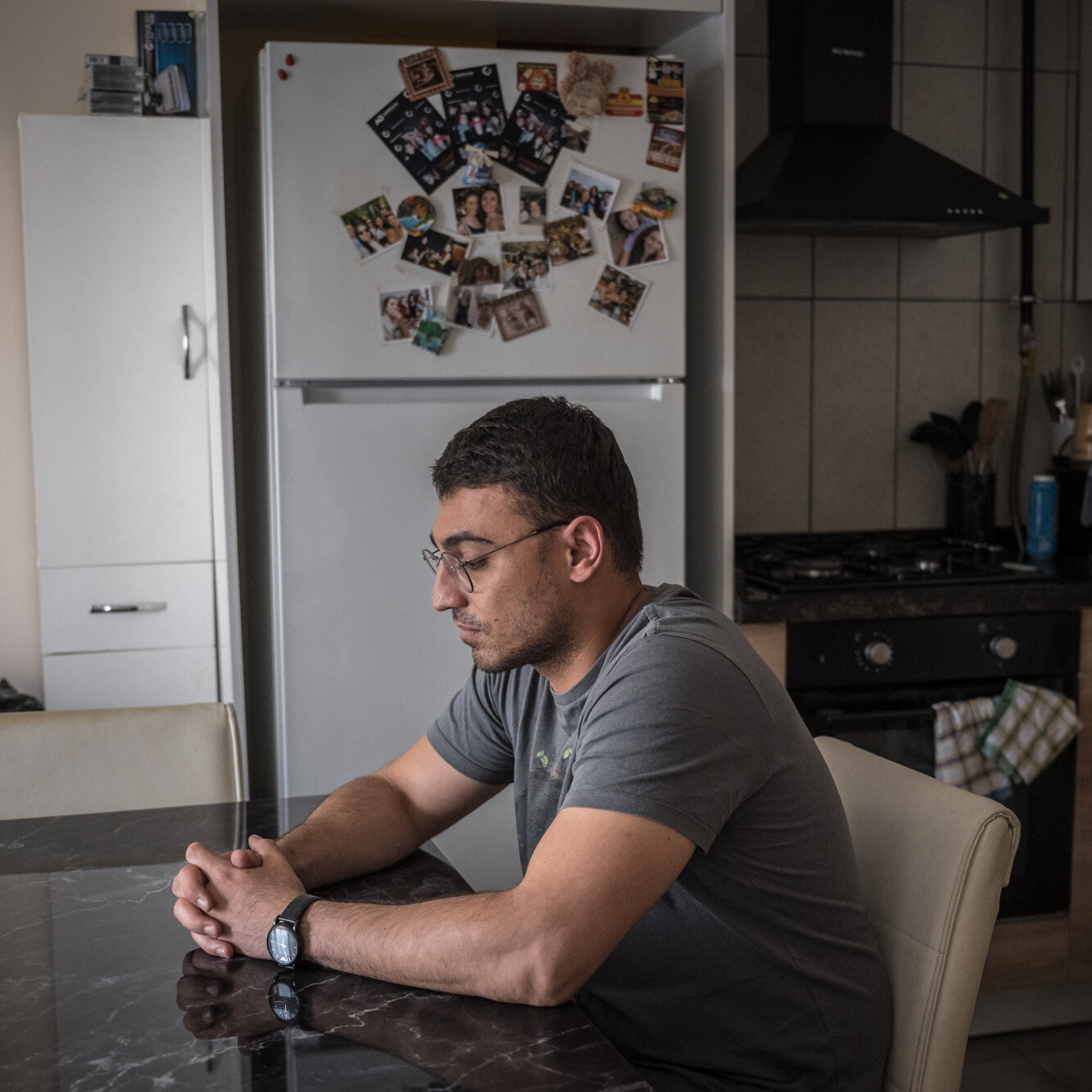 Mustafa Sahin sitting at a kitchen table.