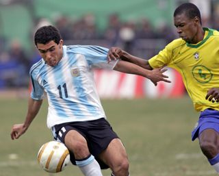 Argentina's Carlos Tevez vies for the ball with Brazil's Juan in the final of the 2004 Copa America.