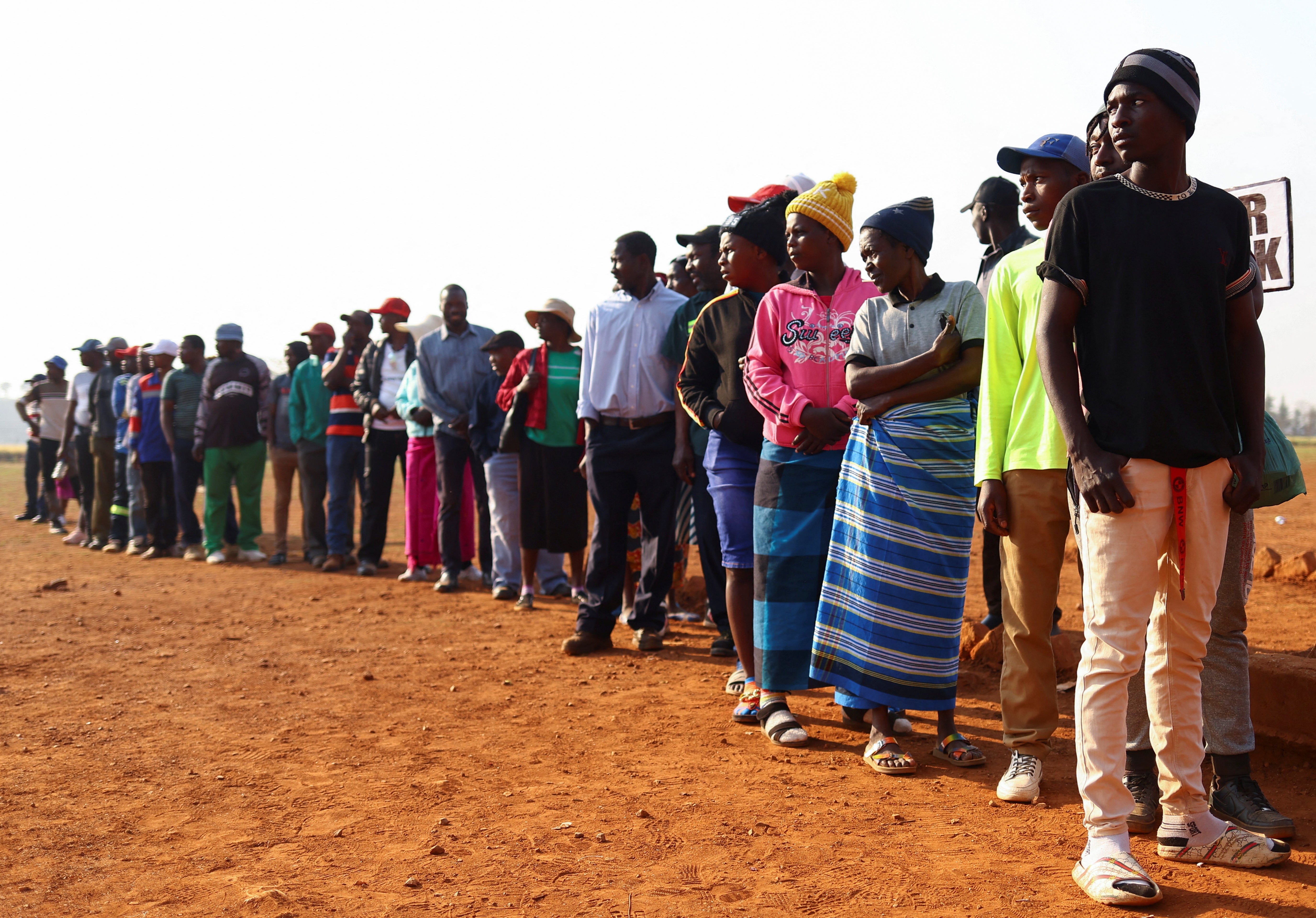 Voters wait in Kwekwe, outside Harare, Zimbabwe on Wednesday